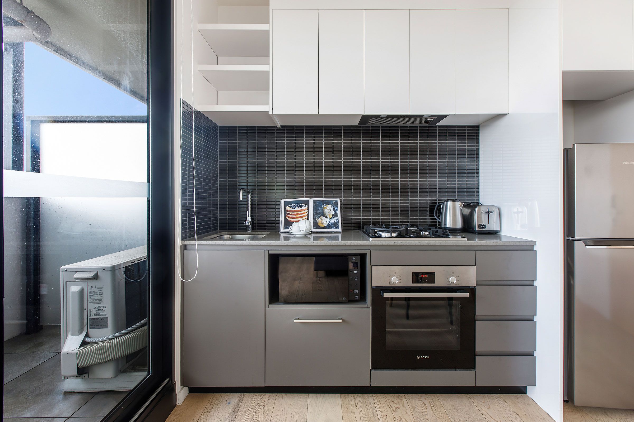 2 Bedroom City View — kitchen with balcony and appliances